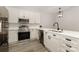 Modern kitchen featuring stainless steel appliances, quartz countertops and sleek white cabinetry at 6204 Half Dome Dr, Charlotte, NC 28269