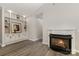 Living room boasting built-in shelving, a fireplace and wood look floors at 6204 Half Dome Dr, Charlotte, NC 28269