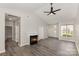 Spacious living room with a fireplace, ceiling fan, and natural light from the front door and window at 6204 Half Dome Dr, Charlotte, NC 28269