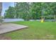 Nice backyard with a well-manicured lawn, patio, white fence and play set for hours of fun at 6310 Trevor Simpson Dr, Indian Trail, NC 28079