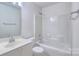 Bright bathroom featuring a white vanity with a sink, toilet, and bathtub with shower at 6310 Trevor Simpson Dr, Indian Trail, NC 28079