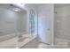 Bathroom with tub, shower, and a vanity with a window providing natural light at 6310 Trevor Simpson Dr, Indian Trail, NC 28079