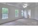Bright bedroom with neutral carpet and three large windows providing plenty of natural light at 6310 Trevor Simpson Dr, Indian Trail, NC 28079