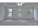 Spacious bedroom featuring carpet, ceiling fan and three windows providing lots of sunlight at 6310 Trevor Simpson Dr, Indian Trail, NC 28079