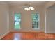Formal dining room featuring hardwood floors, modern light fixture, and bright windows at 6310 Trevor Simpson Dr, Indian Trail, NC 28079