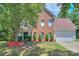 Charming two-story brick home with a well-maintained front yard and mature landscaping at 6310 Trevor Simpson Dr, Indian Trail, NC 28079