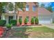 Traditional two-story brick home with manicured landscaping and a well-maintained lawn at 6310 Trevor Simpson Dr, Indian Trail, NC 28079
