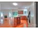 Open concept kitchen with stainless steel appliances, a breakfast bar, and hardwood floors at 6310 Trevor Simpson Dr, Indian Trail, NC 28079