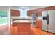 Well-lit kitchen with stainless steel appliances, center island, wood floors and access to outdoor area at 6310 Trevor Simpson Dr, Indian Trail, NC 28079