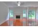 Spacious living room with hardwood floors, fireplace, and sliding glass doors to the backyard at 6310 Trevor Simpson Dr, Indian Trail, NC 28079