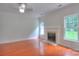 Cozy living room featuring hardwood floors, a fireplace with mantle, and bright double windows at 6310 Trevor Simpson Dr, Indian Trail, NC 28079