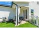 Charming backyard featuring synthetic grass, a white fence, and a cozy seating area by the patio at 651 Melville Dr, Rock Hill, SC 29732