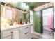 Stylish bathroom featuring a dual vanity, floral wallpaper, and gold-framed mirrors for a luxurious feel at 651 Melville Dr, Rock Hill, SC 29732