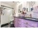 Stylish bathroom with a glass-enclosed shower, dual sink vanity with pink cabinets and black hexagon floor tiles at 651 Melville Dr, Rock Hill, SC 29732