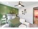 This bedroom features a green accent wall, ceiling fan, and a doorway to another room at 651 Melville Dr, Rock Hill, SC 29732
