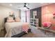 Bright bedroom with a floral accent wall, ceiling fan, and soft, feminine décor at 651 Melville Dr, Rock Hill, SC 29732