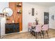 Dining room features a modern table, pink chairs, wood accents, and decorative wall art at 651 Melville Dr, Rock Hill, SC 29732
