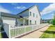 Charming home with a white picket fence, cozy patio with furniture, and lush green grass at 651 Melville Dr, Rock Hill, SC 29732