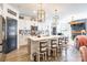 Open concept kitchen features white cabinets, oversized island, stainless steel appliances, and decorative pendant lights at 651 Melville Dr, Rock Hill, SC 29732