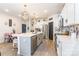 Open kitchen with large island, stainless steel appliances, and adjacent dining area with pink chairs at 651 Melville Dr, Rock Hill, SC 29732