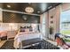 Main bedroom with black ceiling, modern chandelier, wallpaper accent wall, and large windows at 651 Melville Dr, Rock Hill, SC 29732