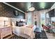 Main bedroom featuring black ceiling, modern chandelier, wallpaper accent wall, and a bright workspace at 651 Melville Dr, Rock Hill, SC 29732