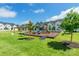 Community playground with slides, climbing structures, picnic tables, and lush green landscaping at 651 Melville Dr, Rock Hill, SC 29732