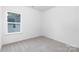 Bedroom with a view from the window and neutral colored walls and soft carpet at 737 Oak St, Charlotte, NC 28214