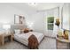 Comfortable bedroom featuring a large window, neutral colored walls and soft carpet at 737 Oak St, Charlotte, NC 28214