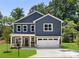 Charming two-story home featuring a well-manicured lawn, an attached two-car garage, and classic curb appeal at 737 Oak St, Charlotte, NC 28214