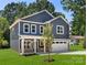 Inviting two-story home with a covered porch, an attached garage, and lush green lawn at 737 Oak St, Charlotte, NC 28214