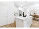 Open kitchen with an island, stainless steel refrigerator, and a view into the dining area at 737 Oak St, Charlotte, NC 28214