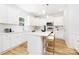 Bright, well-appointed kitchen featuring white cabinetry, stainless appliances, and a breakfast bar at 737 Oak St, Charlotte, NC 28214