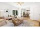 Open-concept living room with a cozy seating area, view of dining and outdoor space at 737 Oak St, Charlotte, NC 28214