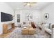Bright living room featuring a modern sofa, stylish decor, and a ceiling fan at 737 Oak St, Charlotte, NC 28214