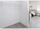Walk-in closet featuring wire shelving with view into bedroom with neutral colored walls and soft carpet at 737 Oak St, Charlotte, NC 28214