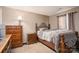 Neutral bedroom featuring a wood-frame bed, dresser, and plenty of natural light at 792 Carolina Mill Cir, Lincolnton, NC 28092