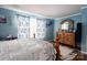 Comfortable bedroom with ample natural light, classic wooden furniture, and stylish decor at 792 Carolina Mill Cir, Lincolnton, NC 28092