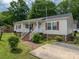 Charming single-story home with a welcoming front porch and well-maintained landscaping at 792 Carolina Mill Cir, Lincolnton, NC 28092