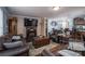 Living room featuring a fireplace, hardwood floors, and comfortable leather seating at 792 Carolina Mill Cir, Lincolnton, NC 28092