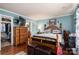 A bedroom with wooden furniture, TV, a walk-in closet, and a glimpse of the bathroom at 792 Carolina Mill Cir, Lincolnton, NC 28092