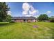 Spacious backyard featuring a well-maintained lawn and a cozy fire pit area at 801 Witmore Rd, Wingate, NC 28174