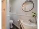 This bathroom offers neutral colors, shower and a large oval mirror at 801 Witmore Rd, Wingate, NC 28174