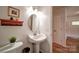 This bathroom features a pedestal sink and a shelf for storage at 801 Witmore Rd, Wingate, NC 28174