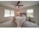 This bedroom is spacious, with carpet, two windows and ceiling fan at 801 Witmore Rd, Wingate, NC 28174