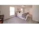 Comfortable bedroom featuring carpet flooring, natural light, and modern accents at 801 Witmore Rd, Wingate, NC 28174
