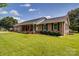 Charming brick ranch-style home with a well-manicured lawn and inviting front porch at 801 Witmore Rd, Wingate, NC 28174