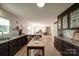Spacious kitchen with granite counters, wood floors, and view into the dining and living rooms at 801 Witmore Rd, Wingate, NC 28174