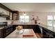 Stylish kitchen featuring granite counters, sleek black appliances, and ample natural light at 801 Witmore Rd, Wingate, NC 28174