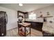 Well-lit kitchen with granite countertops, wood floors, dark cabinets, and modern appliances at 801 Witmore Rd, Wingate, NC 28174